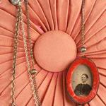 #235
Tin Type surrounded by red velvet, Victorian buttons, brass clock piece, chain
